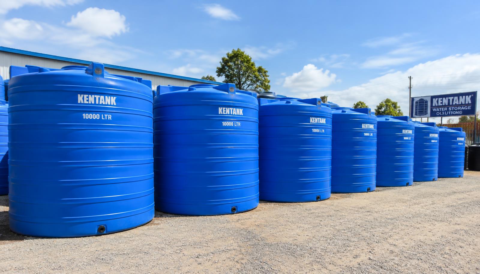 Row of blue water storage tanks in a yard in Kenya